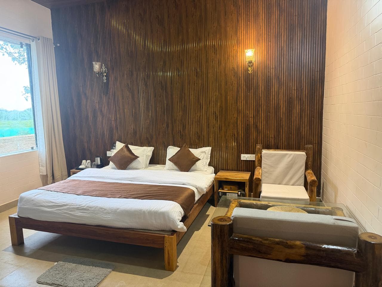 Deluxe Cottage room with rustic furniture and a generous bed